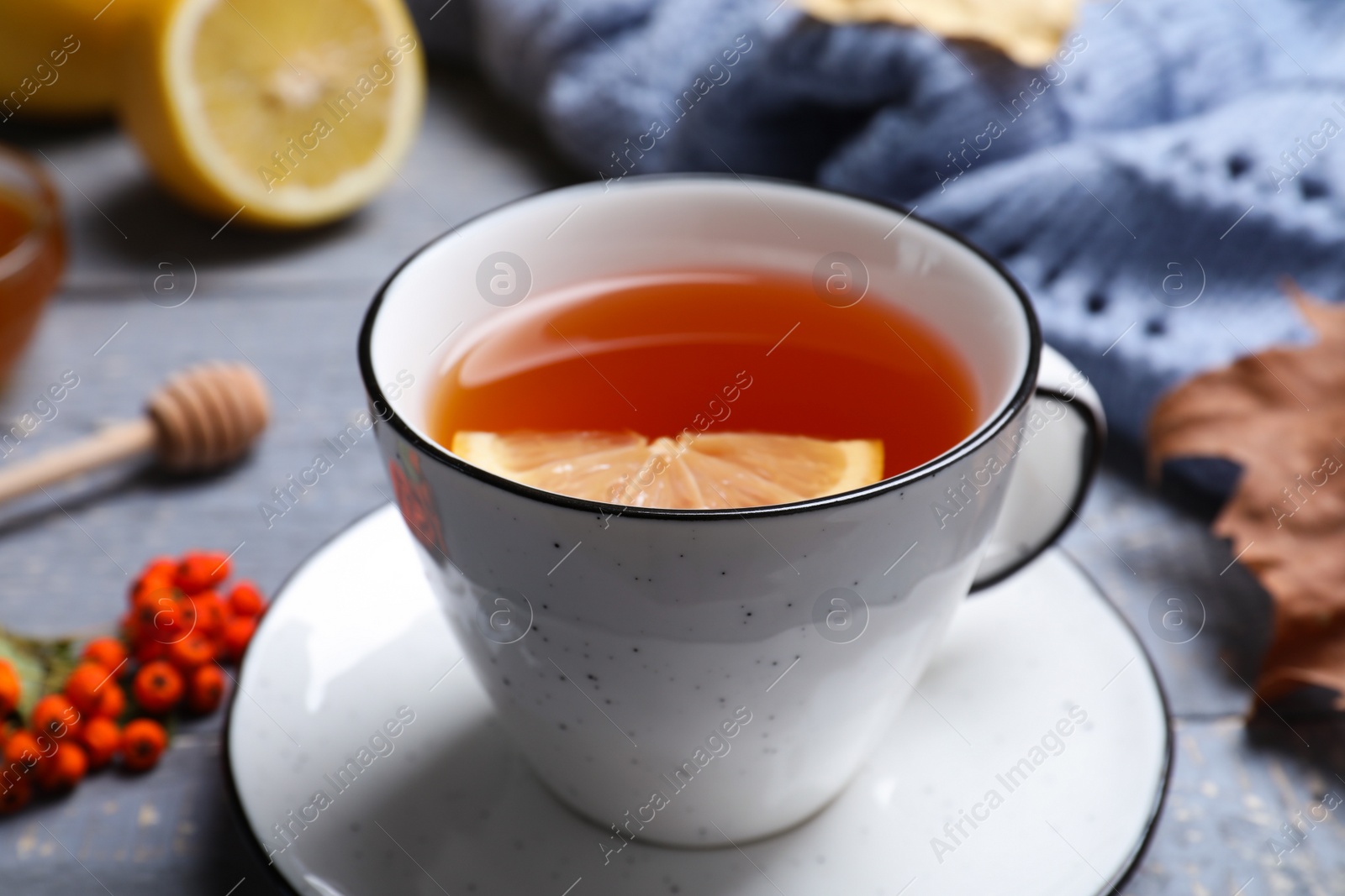 Photo of Cup of hot drink on grey wooden table, closeup. Cozy autumn atmosphere