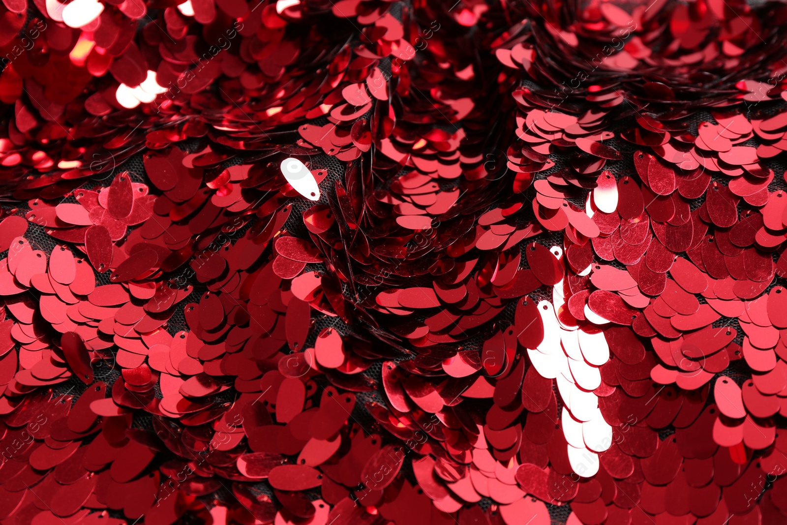 Photo of Closeup view of red shiny sequin fabric as background