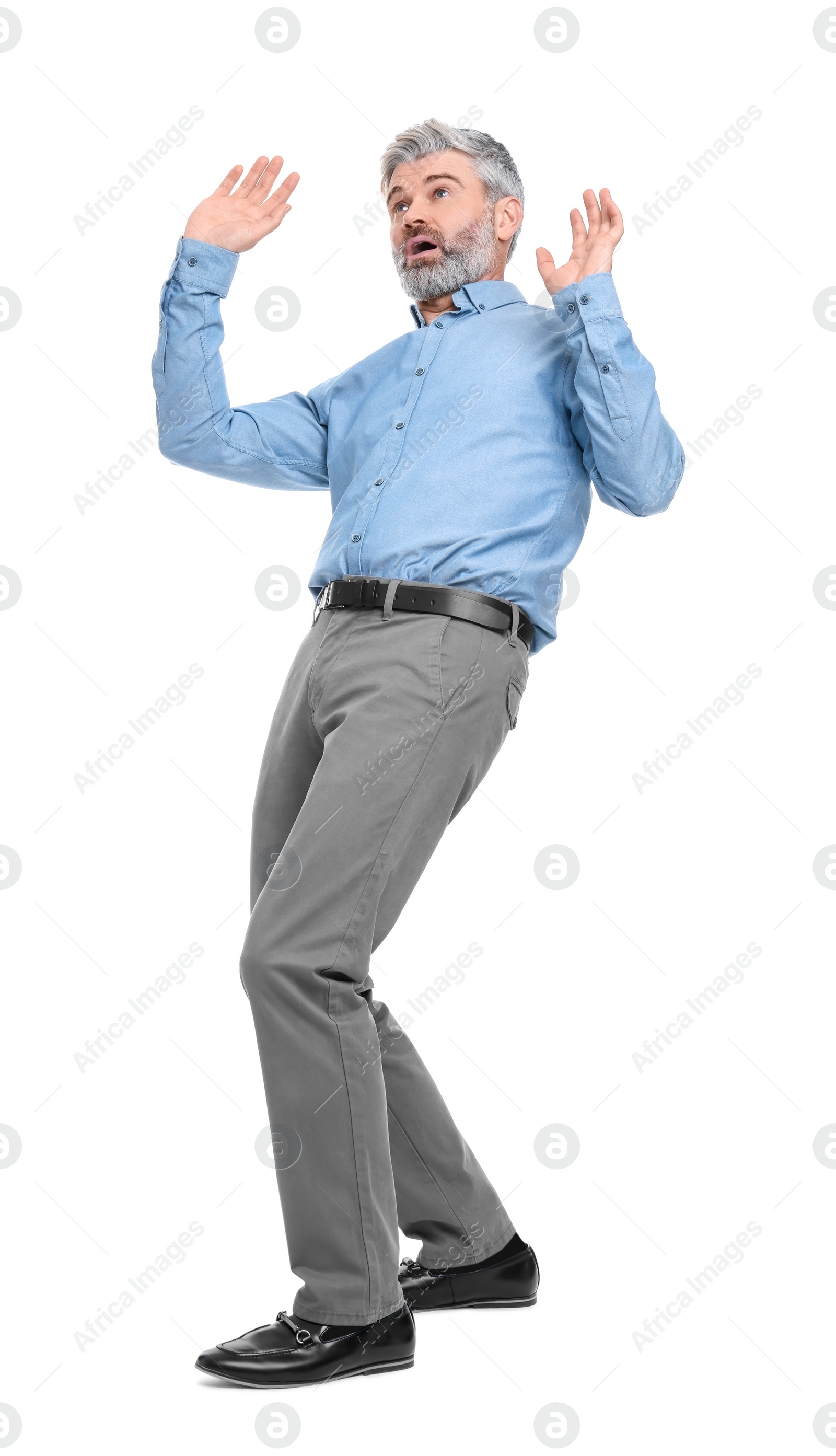 Photo of Mature businessman in stylish clothes avoiding something on white background