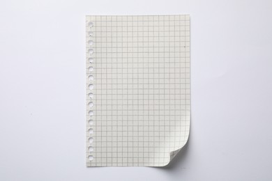 Photo of Checkered sheet of paper on white background, top view