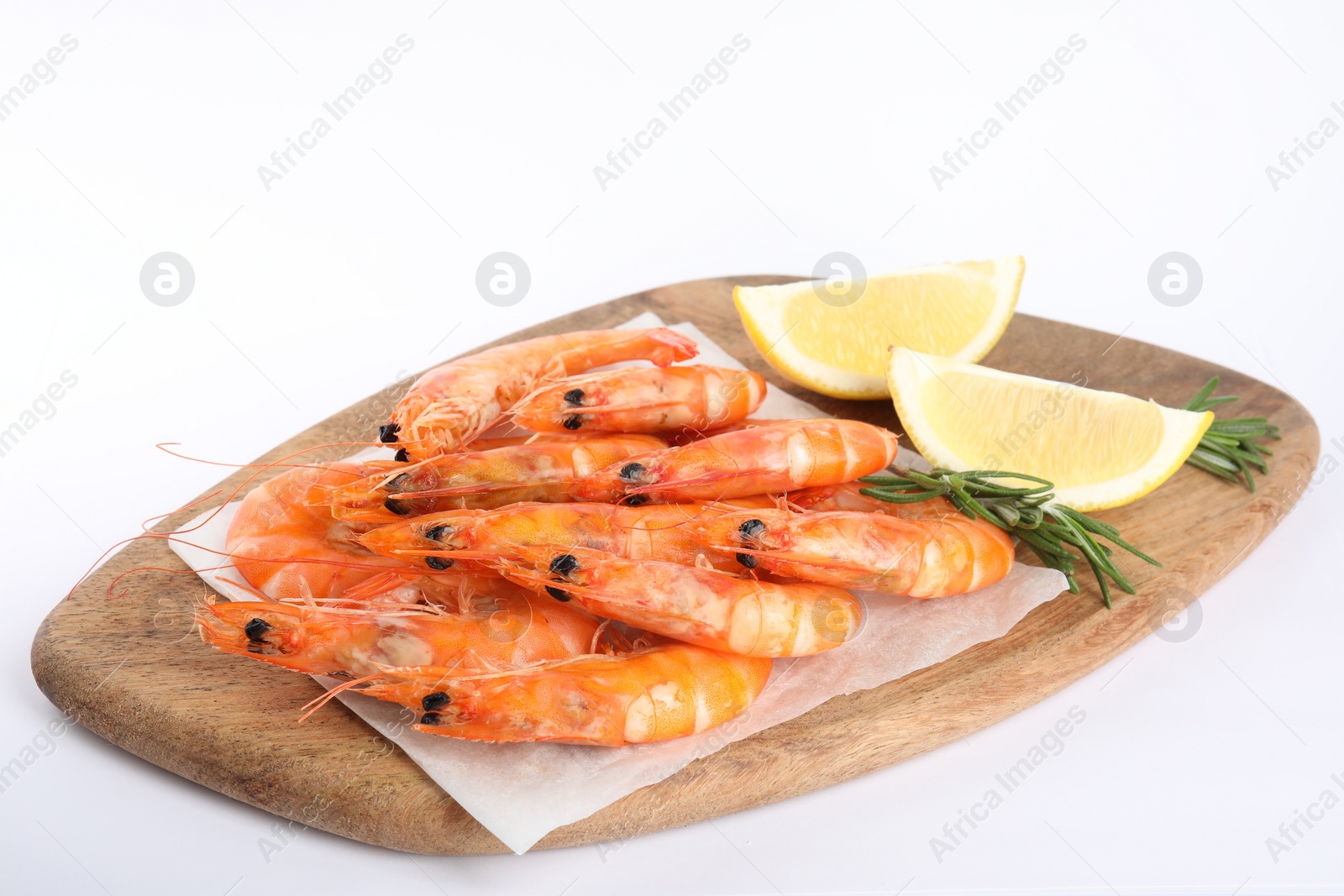 Photo of Delicious cooked shrimps served with lemon and rosemary on white background