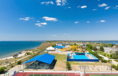 Image of Outdoor water park near sports complex near sea on sunny day 