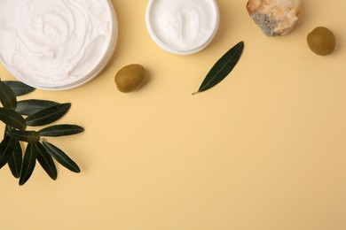 Photo of Natural cosmetic. Different olive creams, mineral and ingredient on beige background, flat lay. Space for text