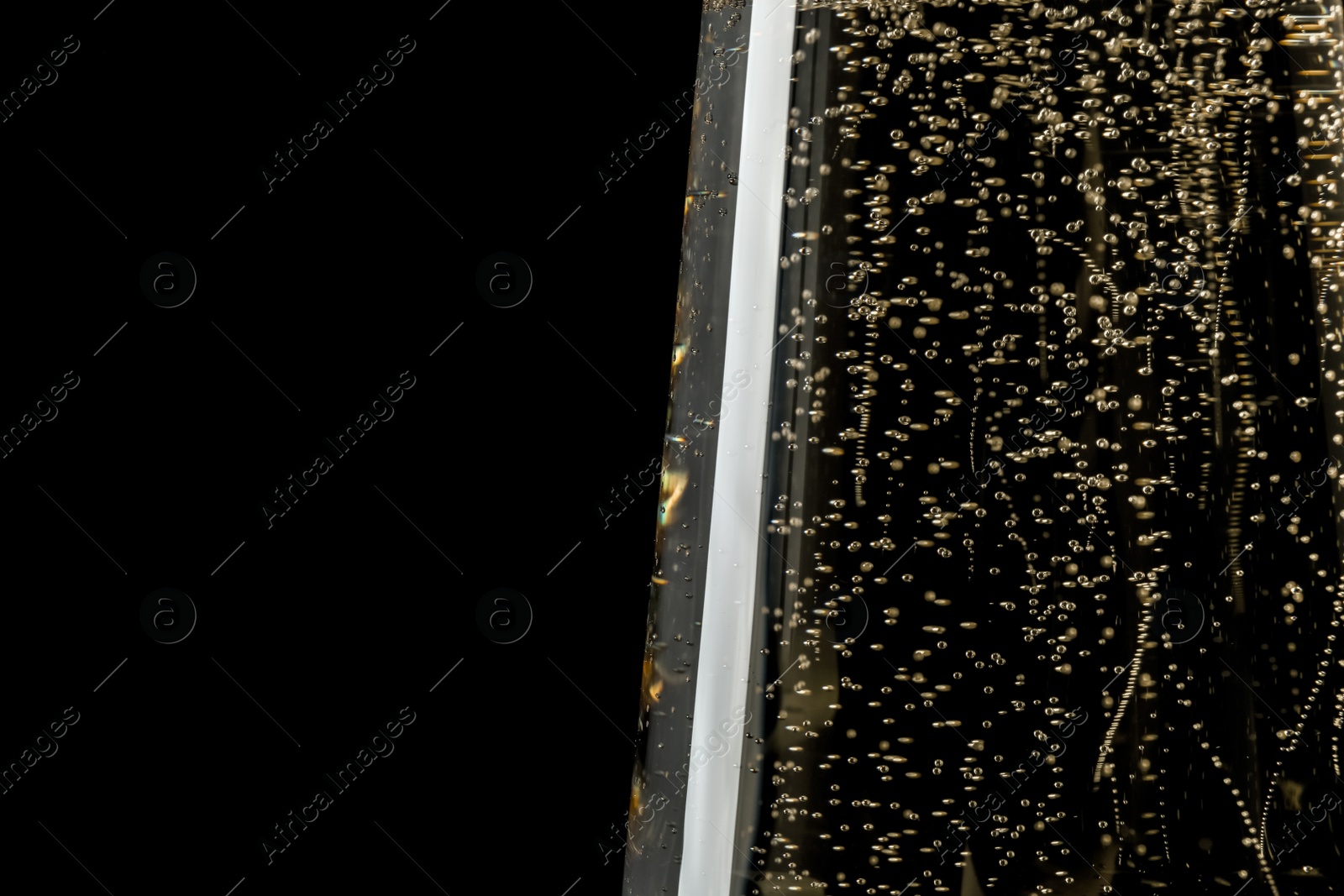 Photo of Glass of champagne on black background, closeup. Space for text