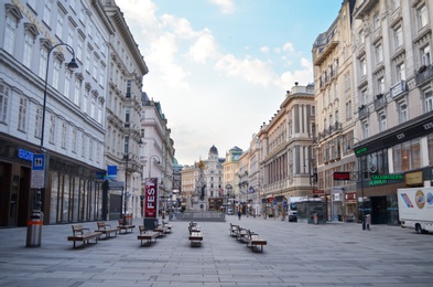 Photo of VIENNA, AUSTRIA - JUNE 18, 2018: Benches on city street near Plague Column