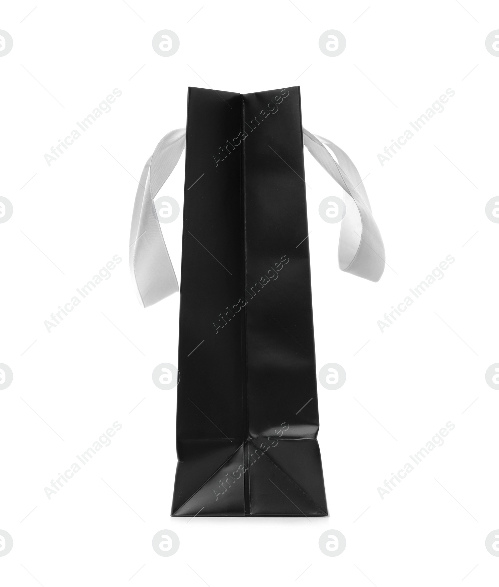 Photo of Paper shopping bag with ribbon handles on white background