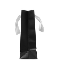 Photo of Paper shopping bag with ribbon handles on white background