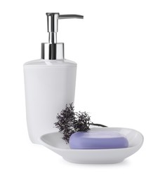 Photo of Dish with soap bar, dispenser and dry flower on white background
