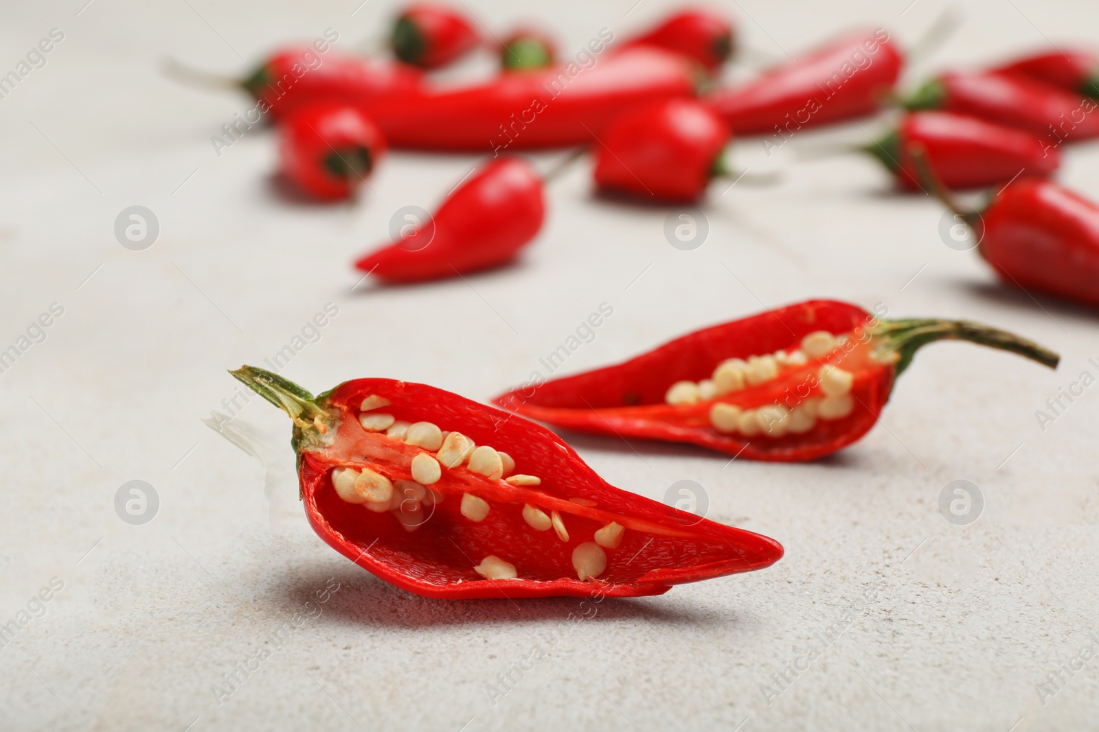 Photo of Cut in halves red chili pepper on table