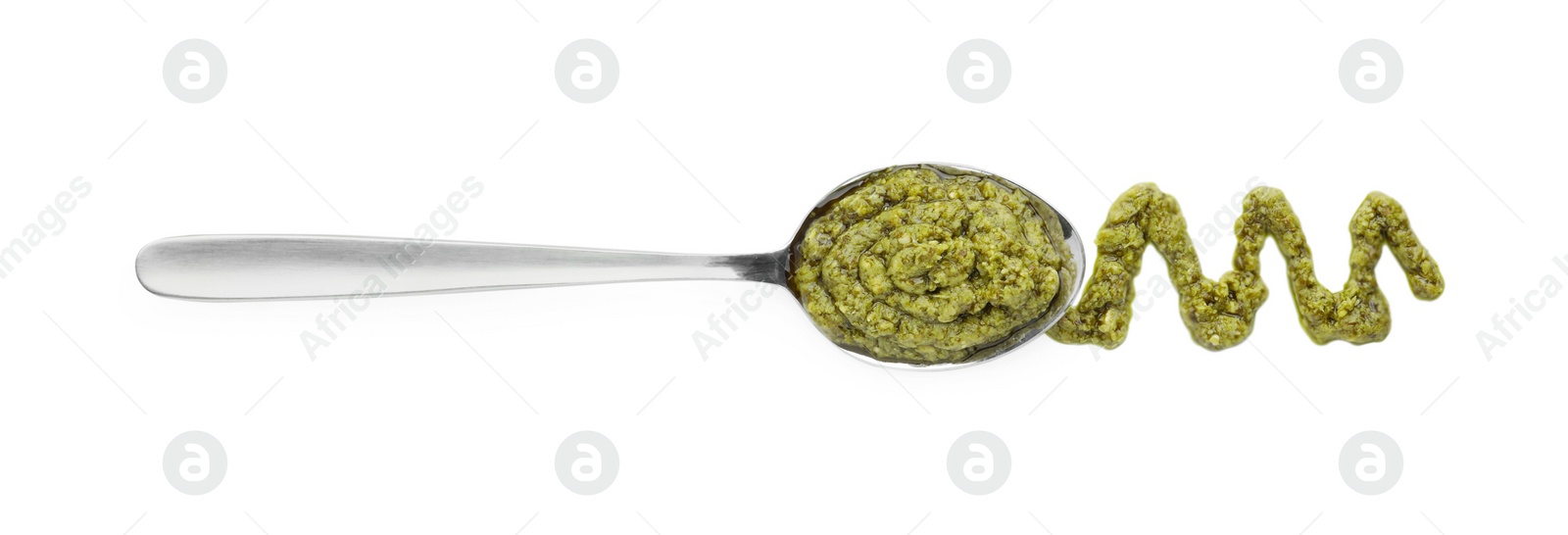 Photo of Tasty pesto sauce and spoon isolated on white, top view