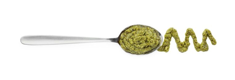 Tasty pesto sauce and spoon isolated on white, top view