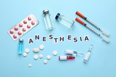 Flat lay composition with word Anesthesia and drugs on light blue background