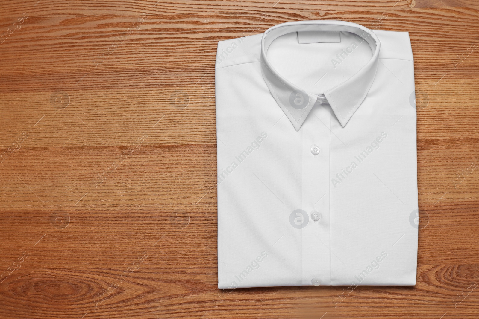 Photo of School uniform on wooden background, top view