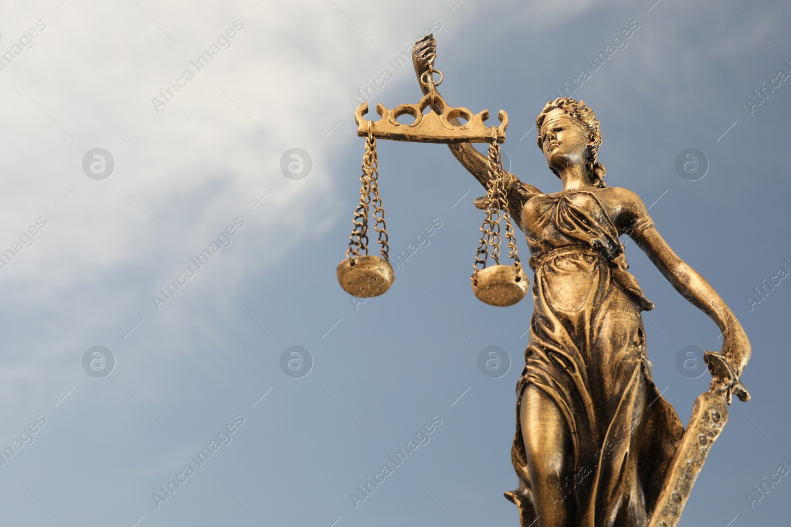 Photo of Symbol of fair treatment under law. Figure of Lady Justice against sky, closeup with space for text