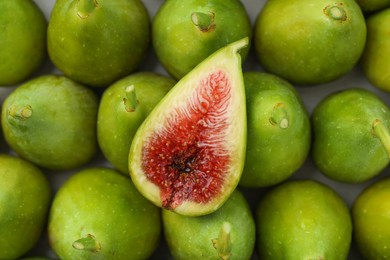 Cut and whole fresh green figs as background, top view