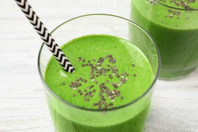 Photo of Tasty kale smoothie on white wooden table, closeup