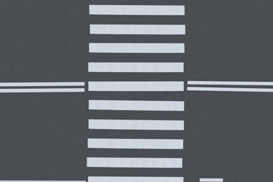 Image of White pedestrian crossing on empty city street, top view