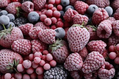 Mix of different frozen berries as background, top view