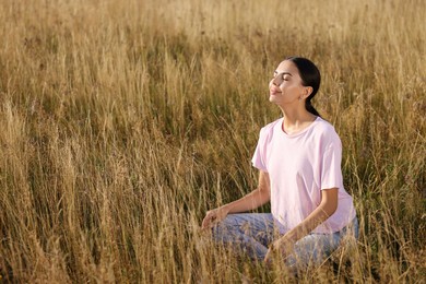 Photo of Woman enjoying feeling of freedom on reed grass meadow