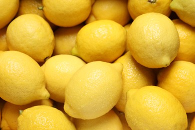 Fresh lemons with water drops as background, closeup