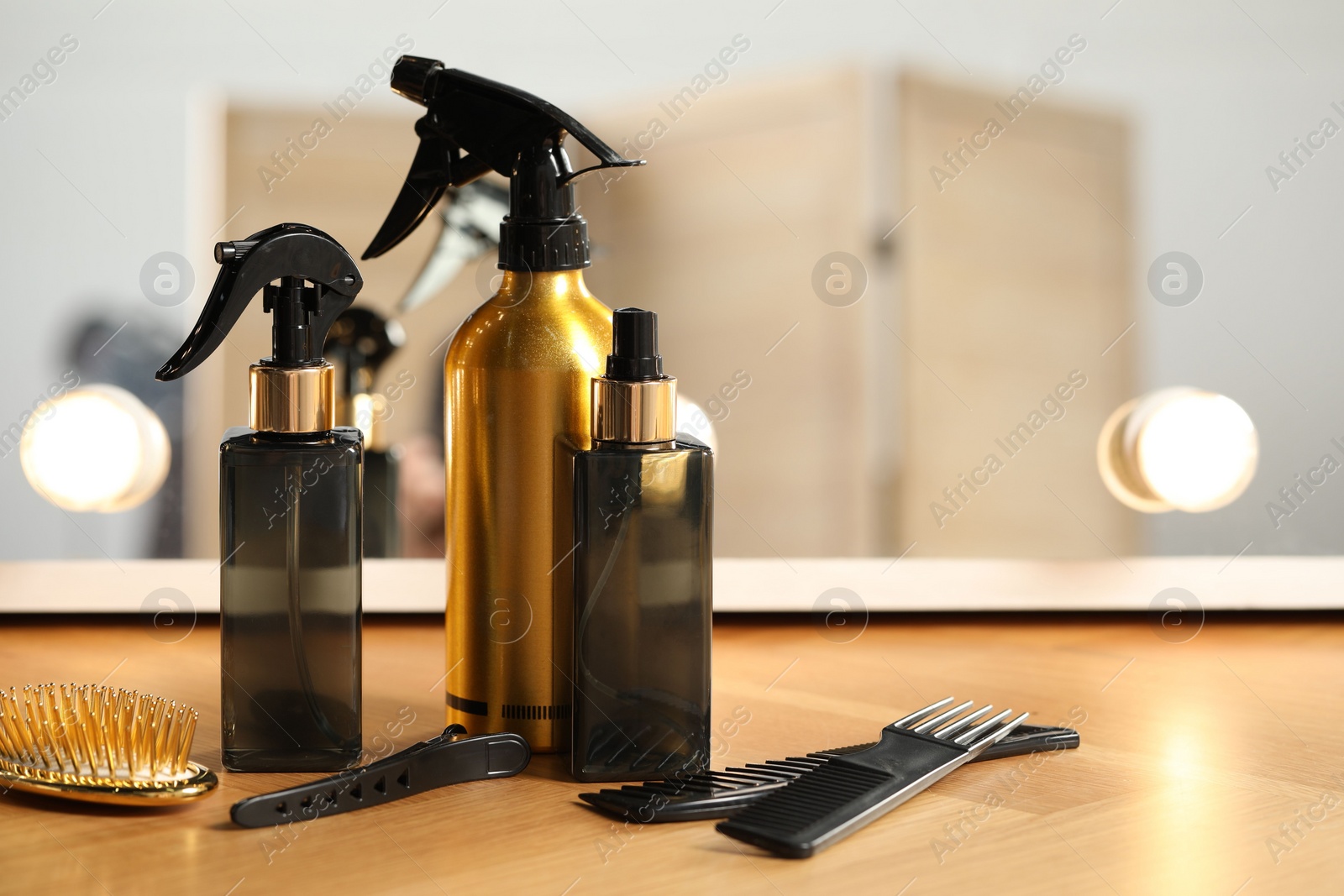 Photo of Set of hairdresser tools on table in salon, space for text