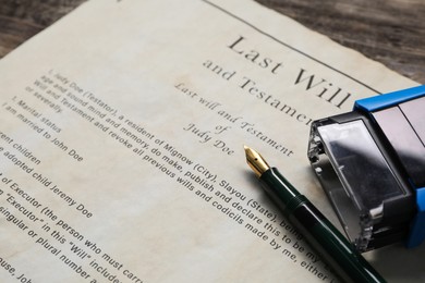 Photo of Last Will and Testament with fountain pen and stamp on table, closeup