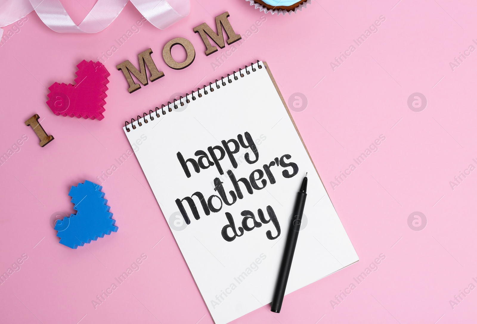 Photo of Notebook with phrase HAPPY MOTHER'S DAY on color background