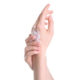 Young woman applying hand cream against on white background