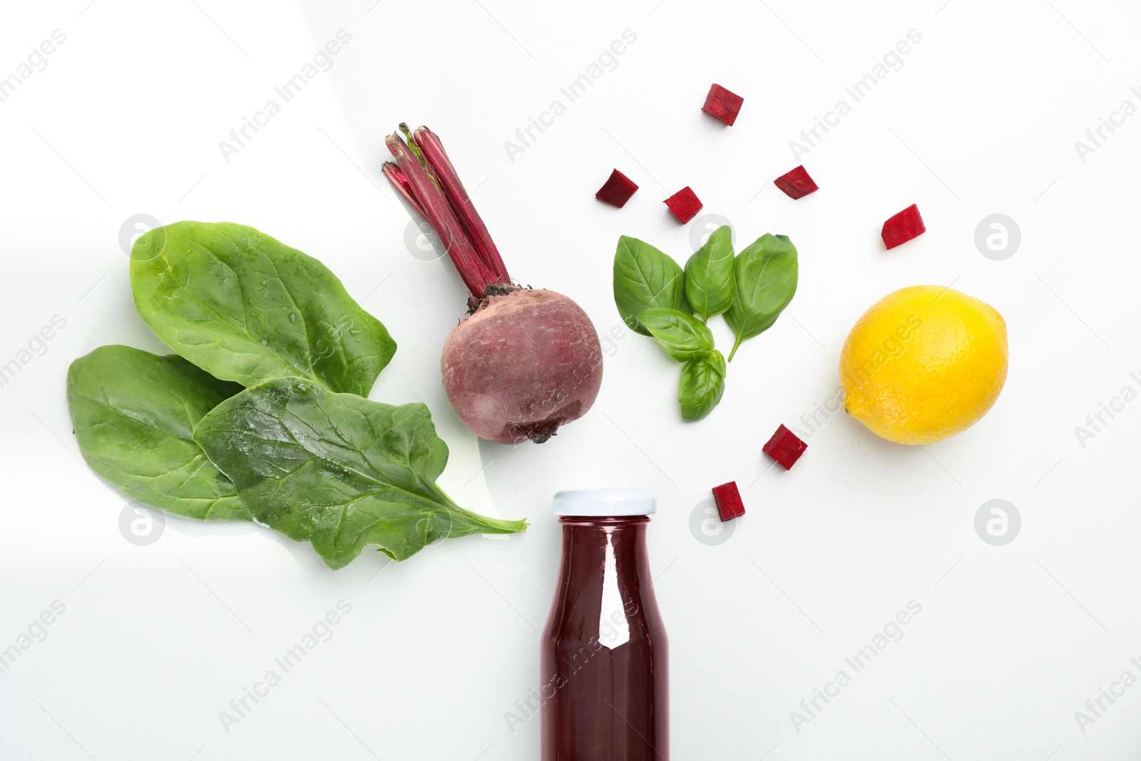 Photo of Glass bottle of fresh juice and ingredients on white background, top view