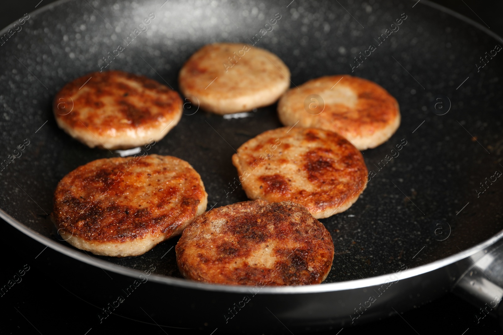 Photo of Cooking vegan cutlets in frying pan, closeup