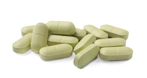 Photo of Light green vitamin pills isolated on white