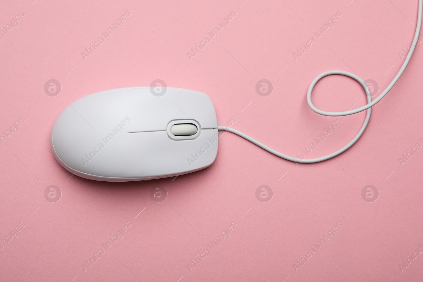 Photo of Wired computer mouse on pink background, top view