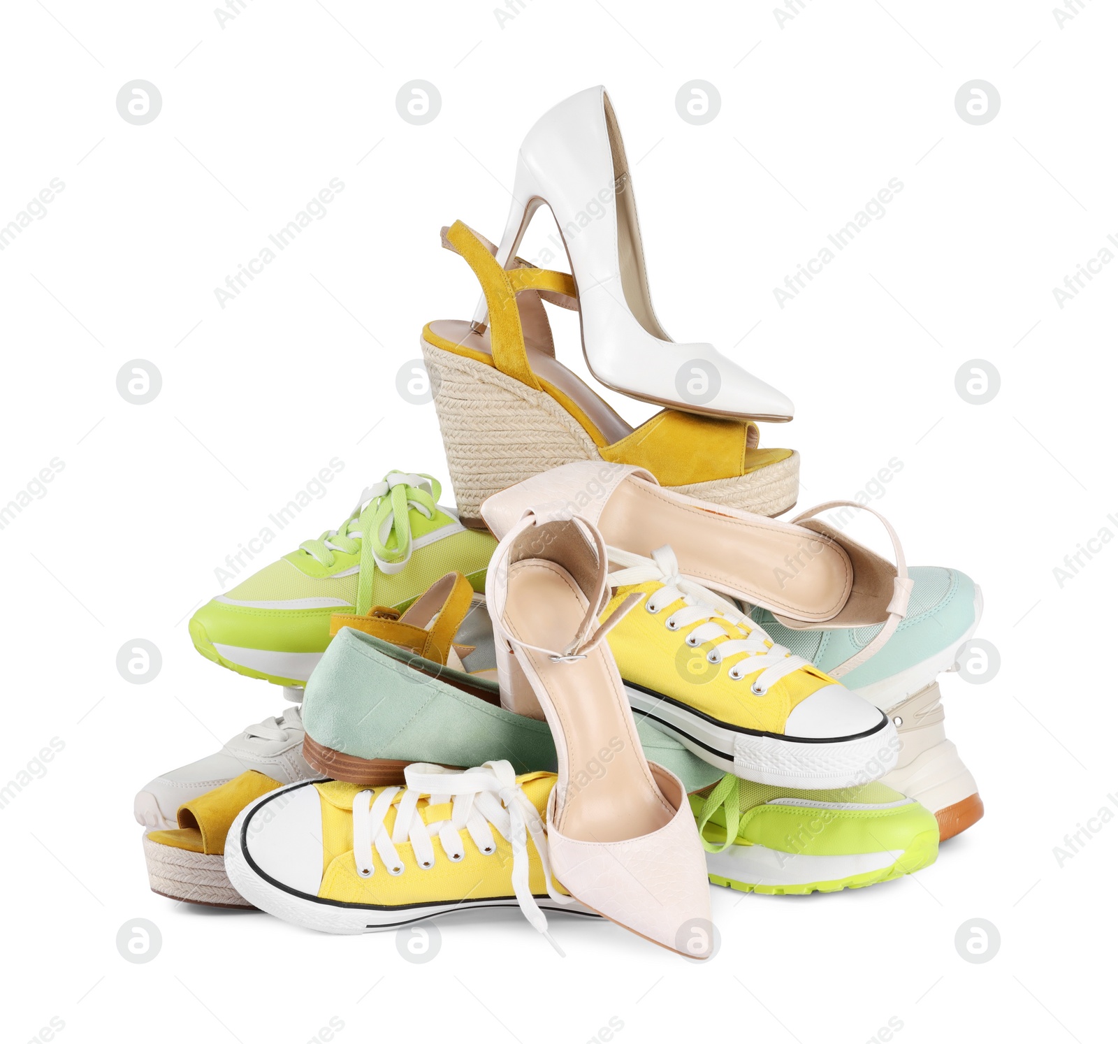 Photo of Pile of different female shoes isolated on white