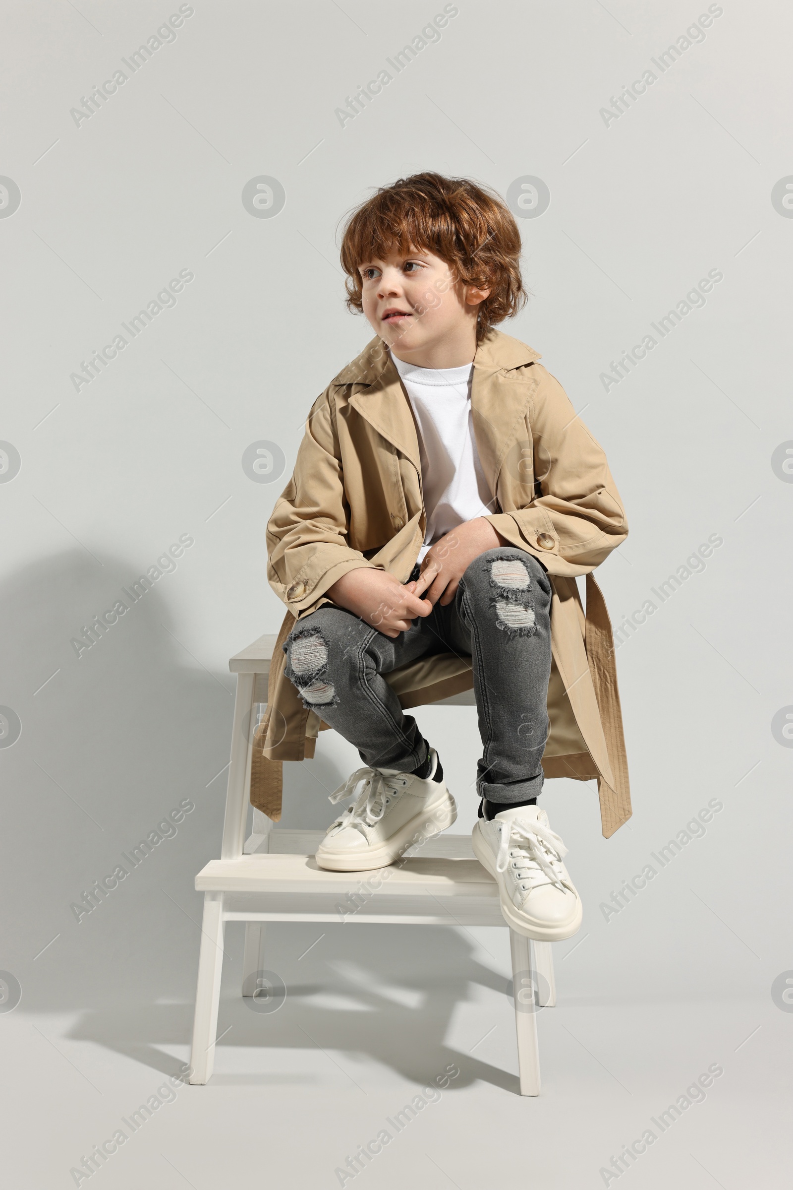 Photo of Fashion concept. Stylish boy posing on light grey background