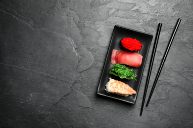 Set of delicious sushi on grey table, flat lay. Space for text