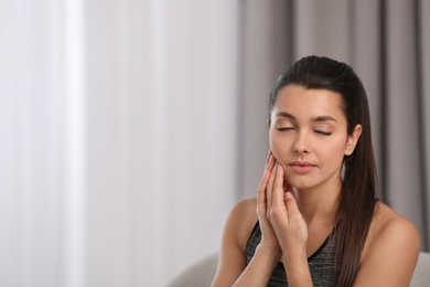 Photo of Young woman with sensitive teeth indoors. Space for text