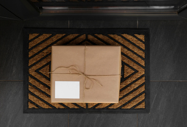 Photo of Delivered parcel on door mat near entrance, top view