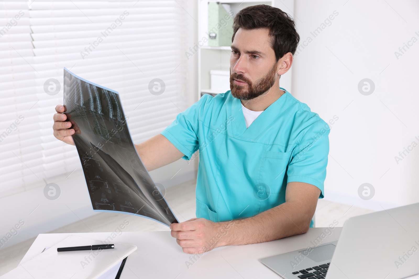 Photo of Doctor examining neck MRI scan in hospital