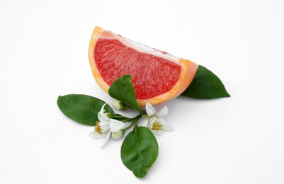 Photo of Cut fresh ripe grapefruit and green leaves on white background