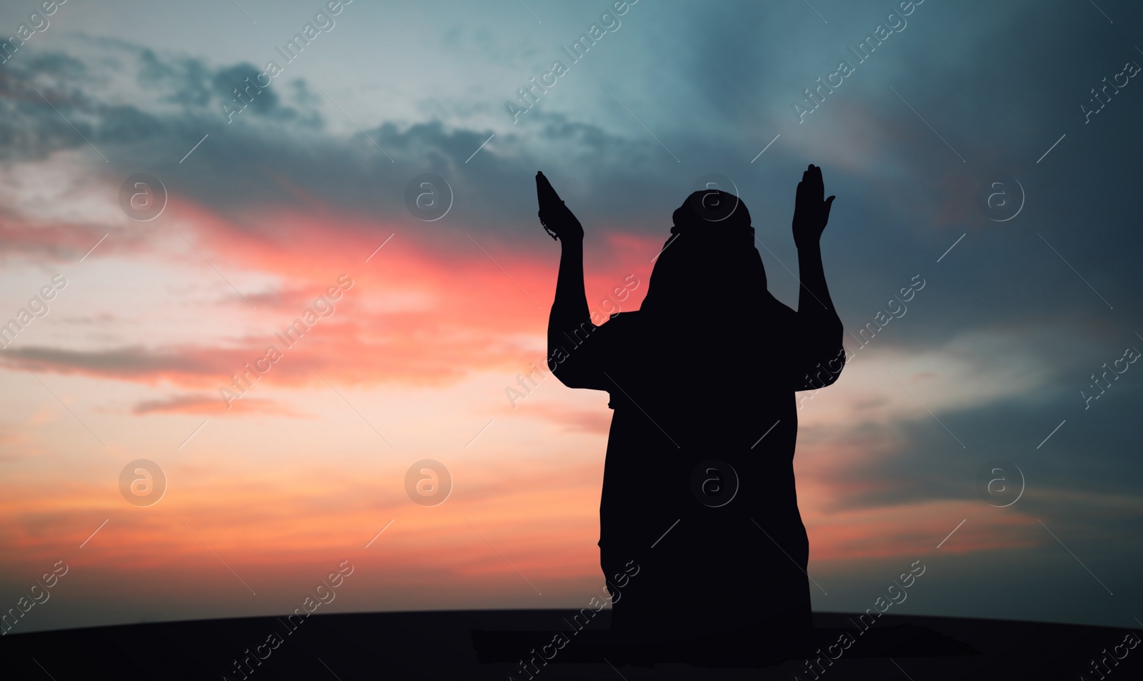 Image of Silhouette of Muslim man praying outdoors. Holy month of Ramadan