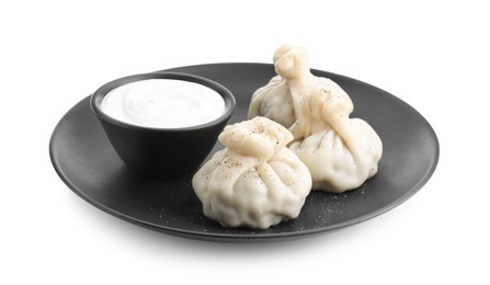 Tasty khinkali (dumplings) with sauce and spices isolated on white. Georgian cuisine