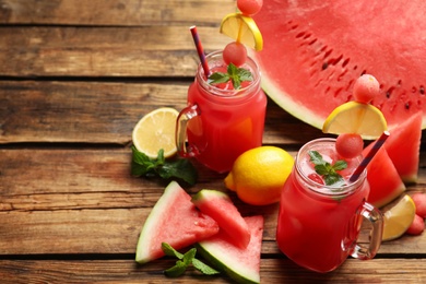 Photo of Delicious fresh watermelon drink on wooden table. Space for text