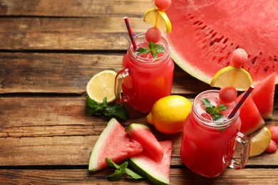 Delicious fresh watermelon drink on wooden table. Space for text