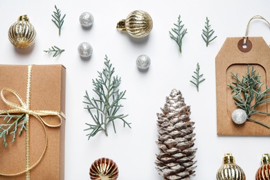 Flat lay composition with Christmas gift and festive decor on white background