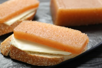 Photo of Tasty sandwich with quince paste on table, closeup