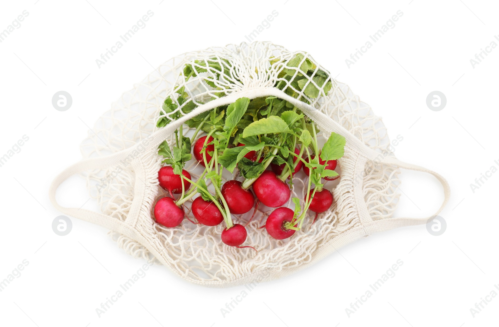 Photo of String bag with radishes isolated on white, top view