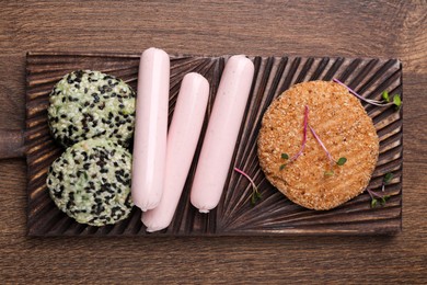 Different vegan products on wooden table, top view