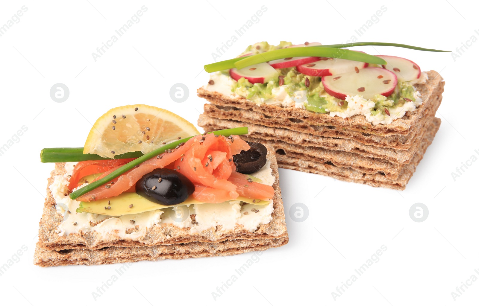 Photo of Fresh crunchy crispbreads with cream cheese, salmon, olives, lemon, radish green onion on white background