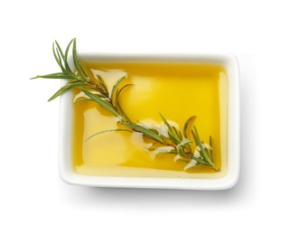 Photo of Bowl of rosemary oil with fresh twig on white background, top view