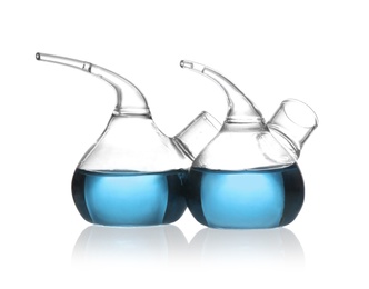 Retort flasks with blue liquid isolated on white. Laboratory glassware